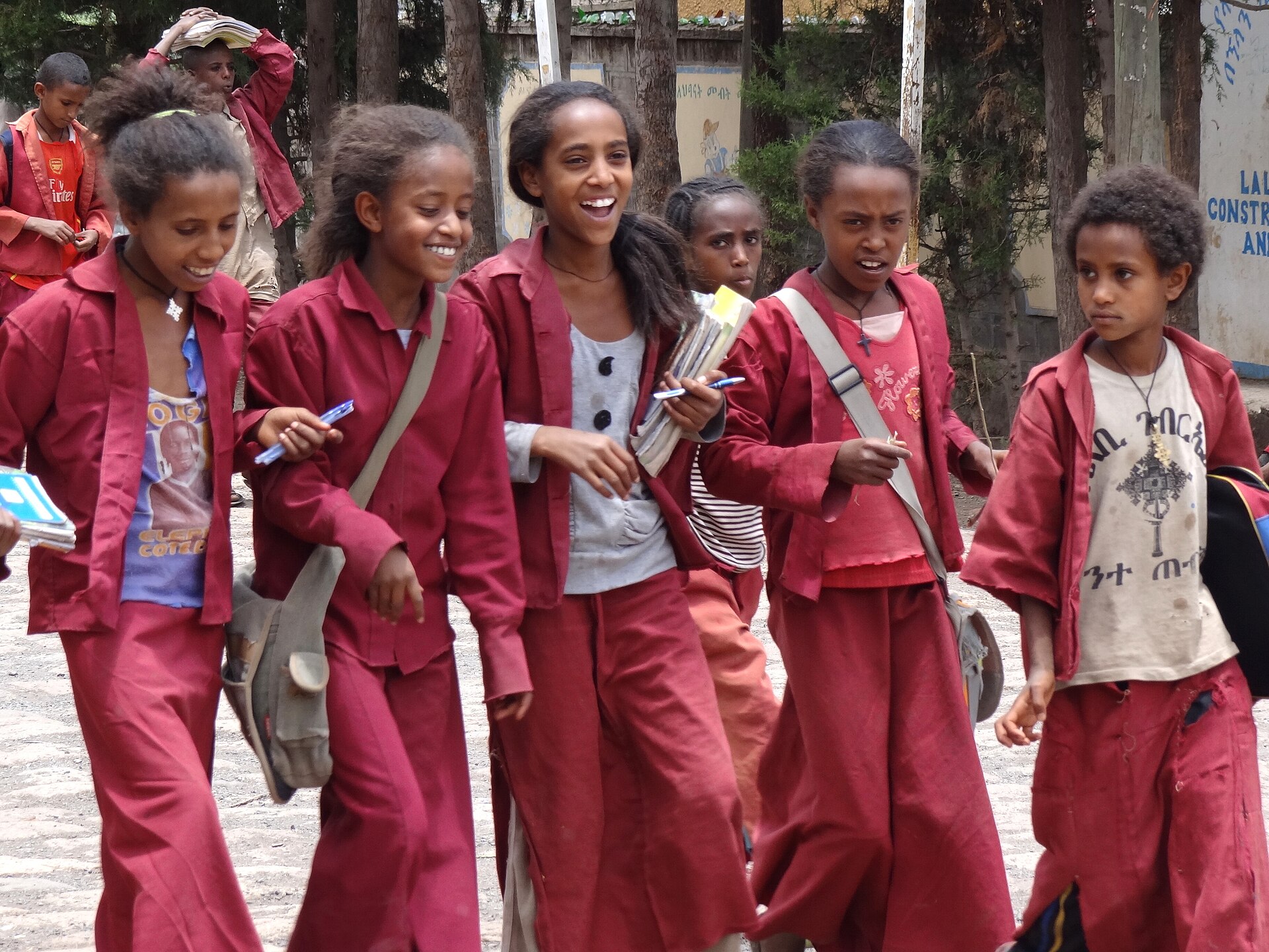 Students in school uniforms walking together with their books